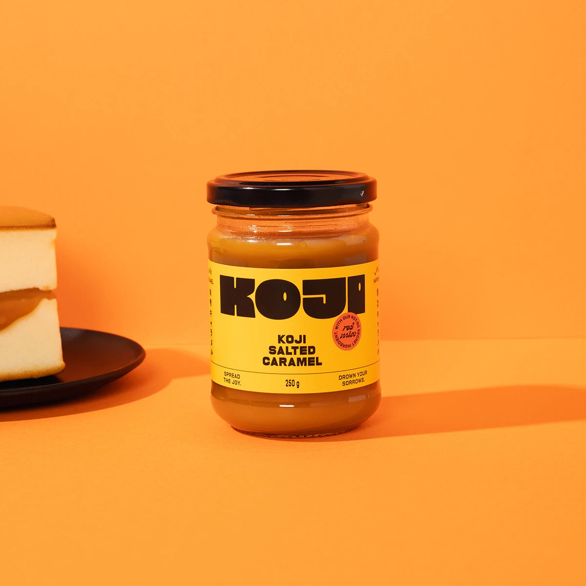 Jar of Koji salted caramel on an orange background
