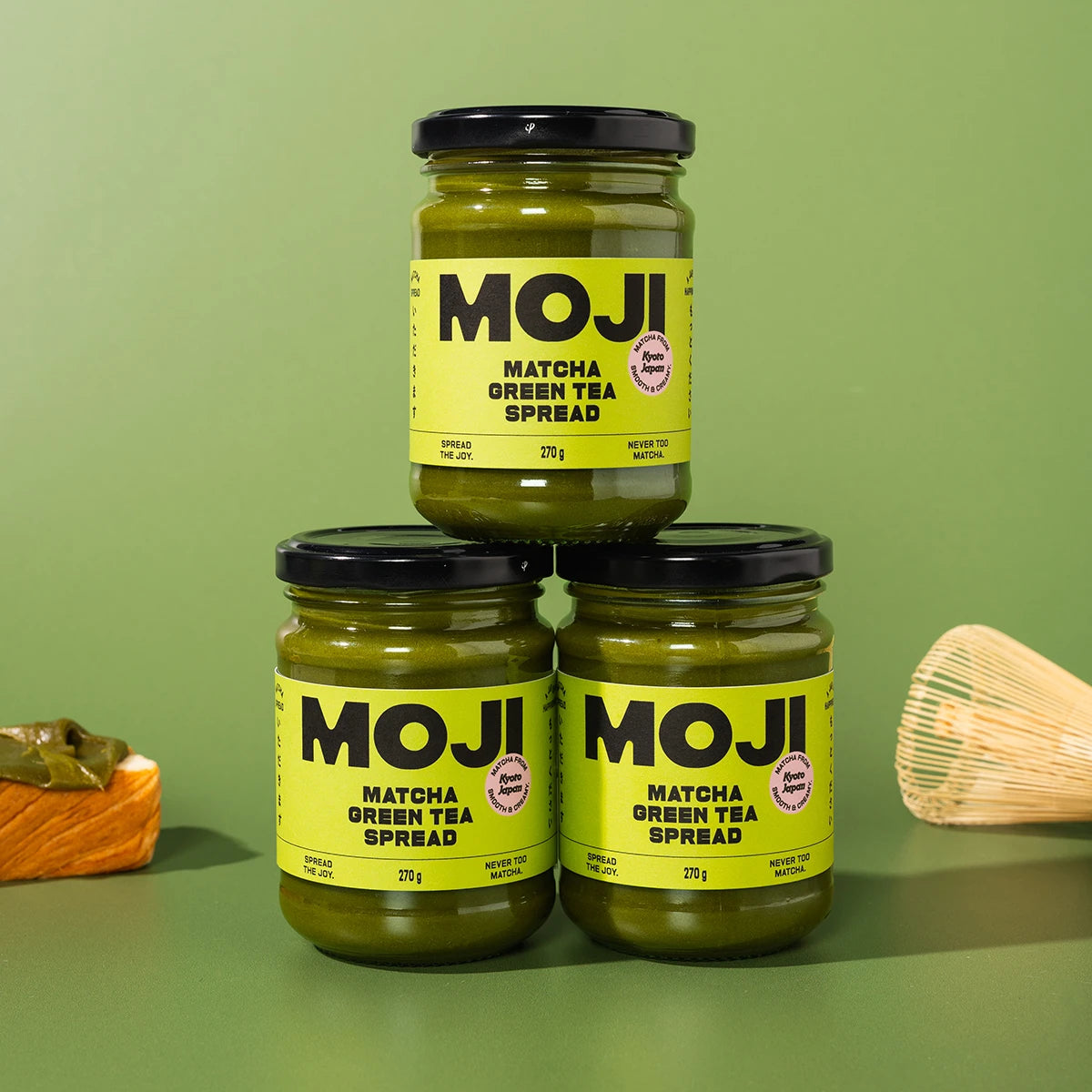 Three jars of MOJI Matcha Green Tea Spread on a green background
